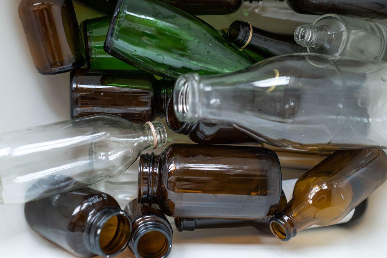 A detailed view of assorted recyclable glass bottles, showcasing their potential for reuse and environmental sustainability.