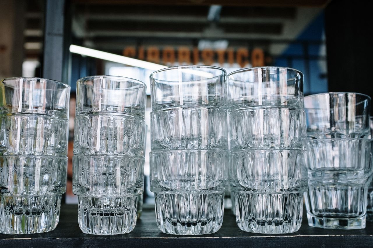 Close-up of stacked empty glasses in a contemporary café with an industrial vibe.