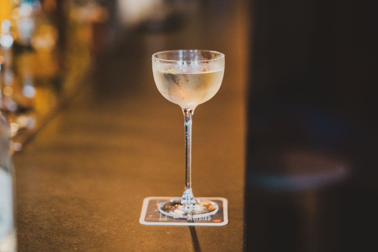Close-up of a cocktail on a bar, showing exquisite focus and ambiance.